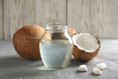 Photo of Composition with coconut oil on grey wooden table