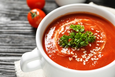 Dish with fresh homemade tomato soup on table, closeup