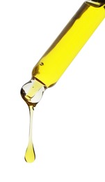 Photo of Dripping yellow facial serum from pipette on white background, closeup