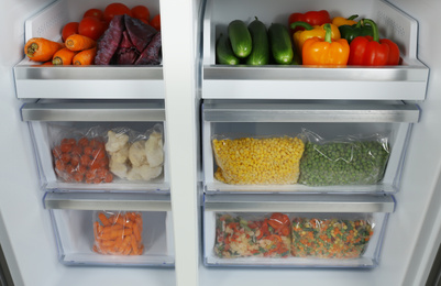 Photo of Open refrigerator full of different fresh products