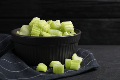 One bowl of fresh cut celery on grey table, closeup