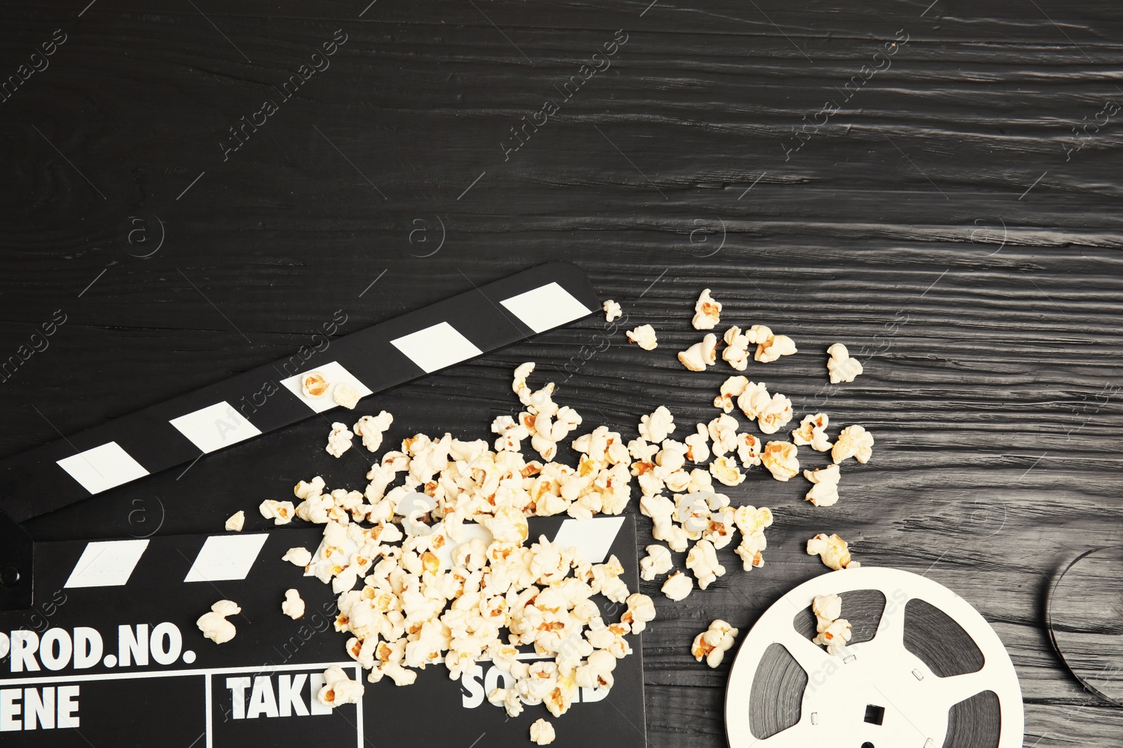 Photo of Flat lay composition with tasty popcorn and space for text on wooden background. Cinema snack