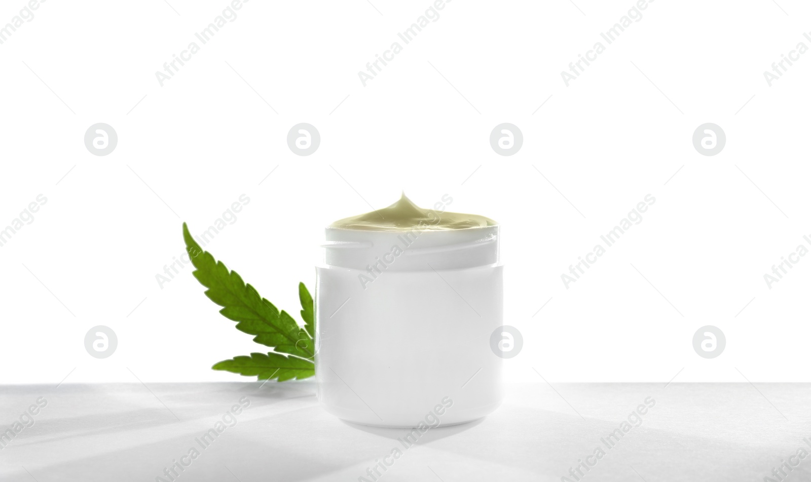 Photo of Jar with hemp lotion on white background