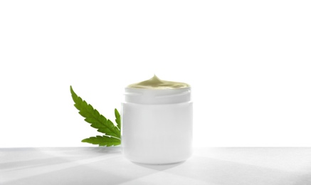 Photo of Jar with hemp lotion on white background