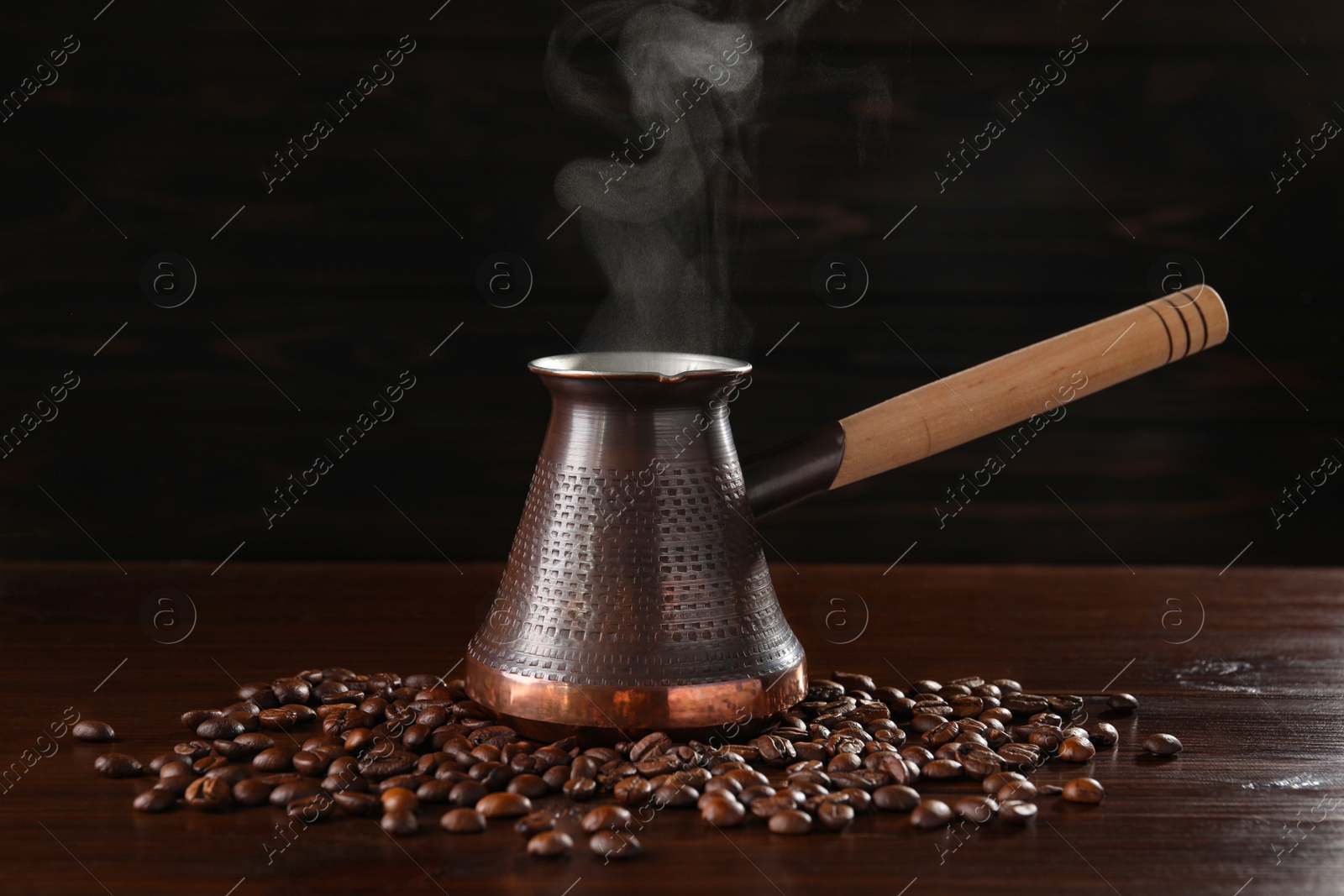 Photo of Turkish coffee in cezve and beans on wooden table