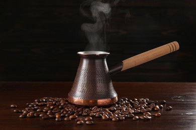 Turkish coffee in cezve and beans on wooden table