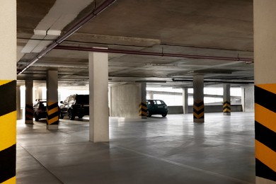 Photo of Open parking garage with cars on sunny day