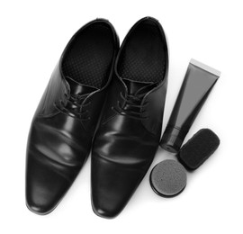 Stylish footwear and shoe care products on white background, top view