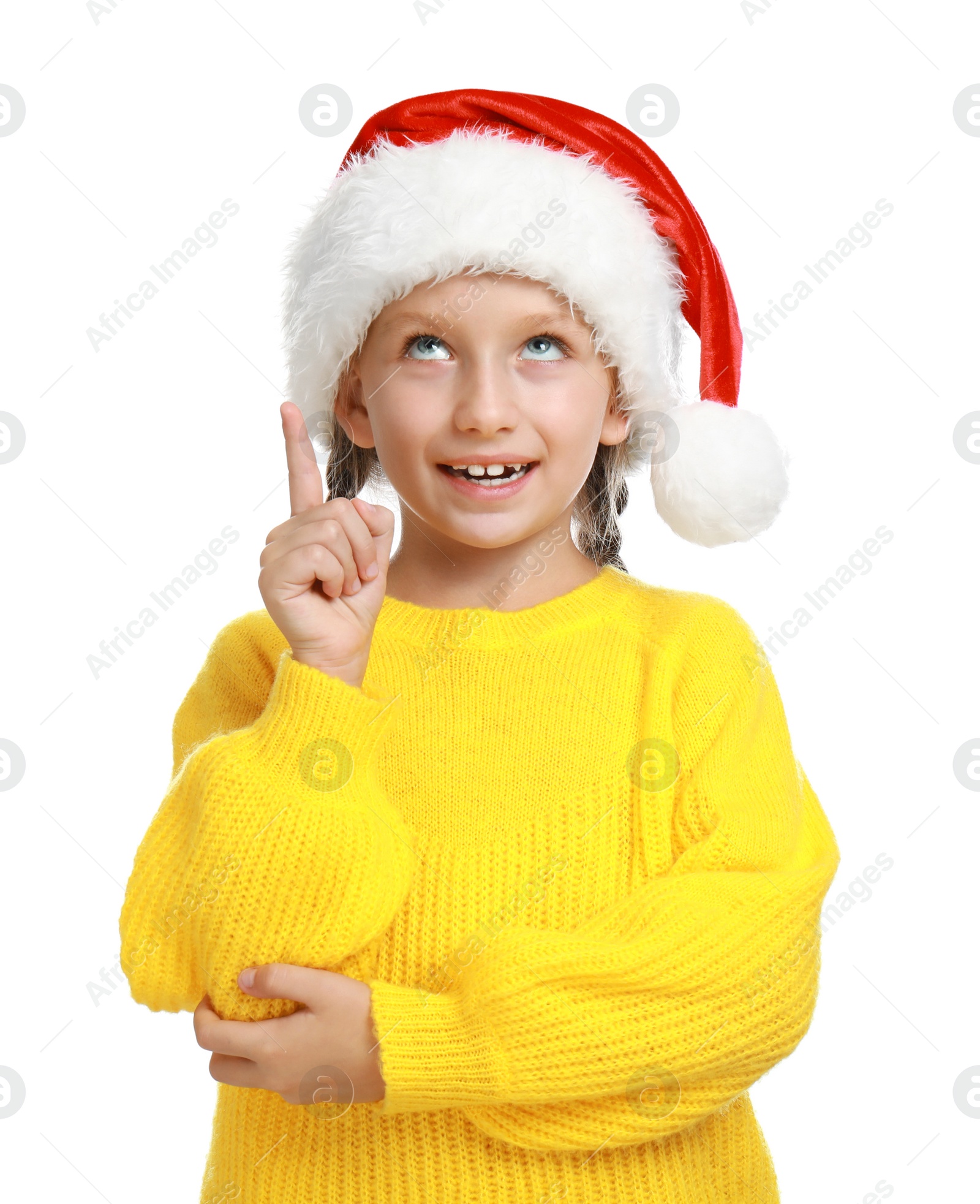 Photo of Happy little child in Santa hat on white background. Christmas celebration