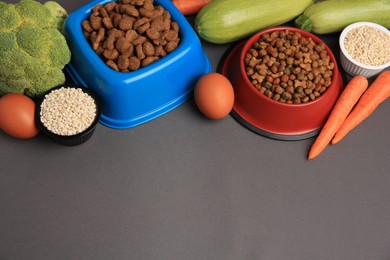 Dry pet food and products on black background, space for text