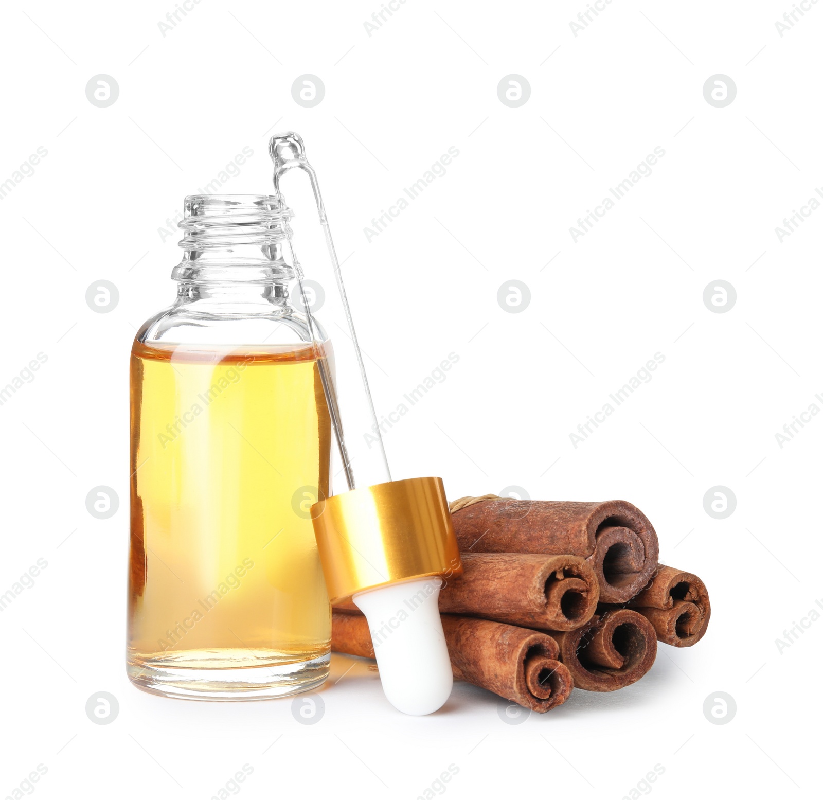 Photo of Bottle of essential oil and cinnamon sticks on white background