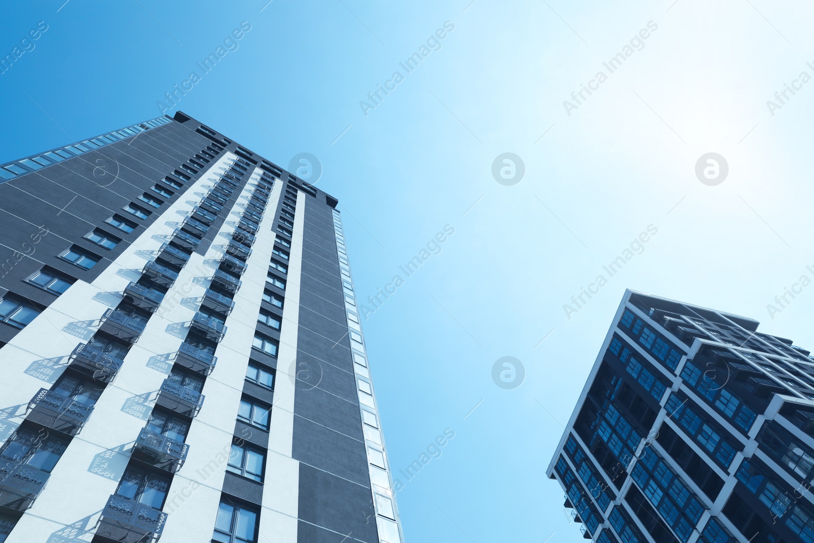 Photo of Low angle view of modern buildings on sunny day