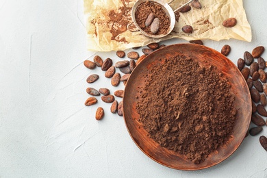 Photo of Flat lay composition with cocoa powder and beans on light background