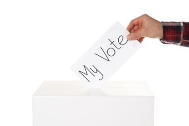 Man putting his vote into ballot box on white background, closeup