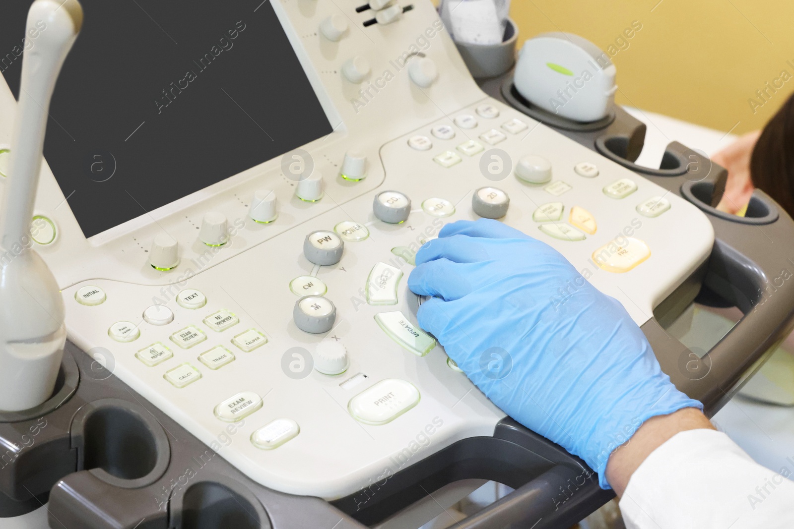 Photo of Mammologist conducting ultrasound examination of woman's breast in clinic, closeup