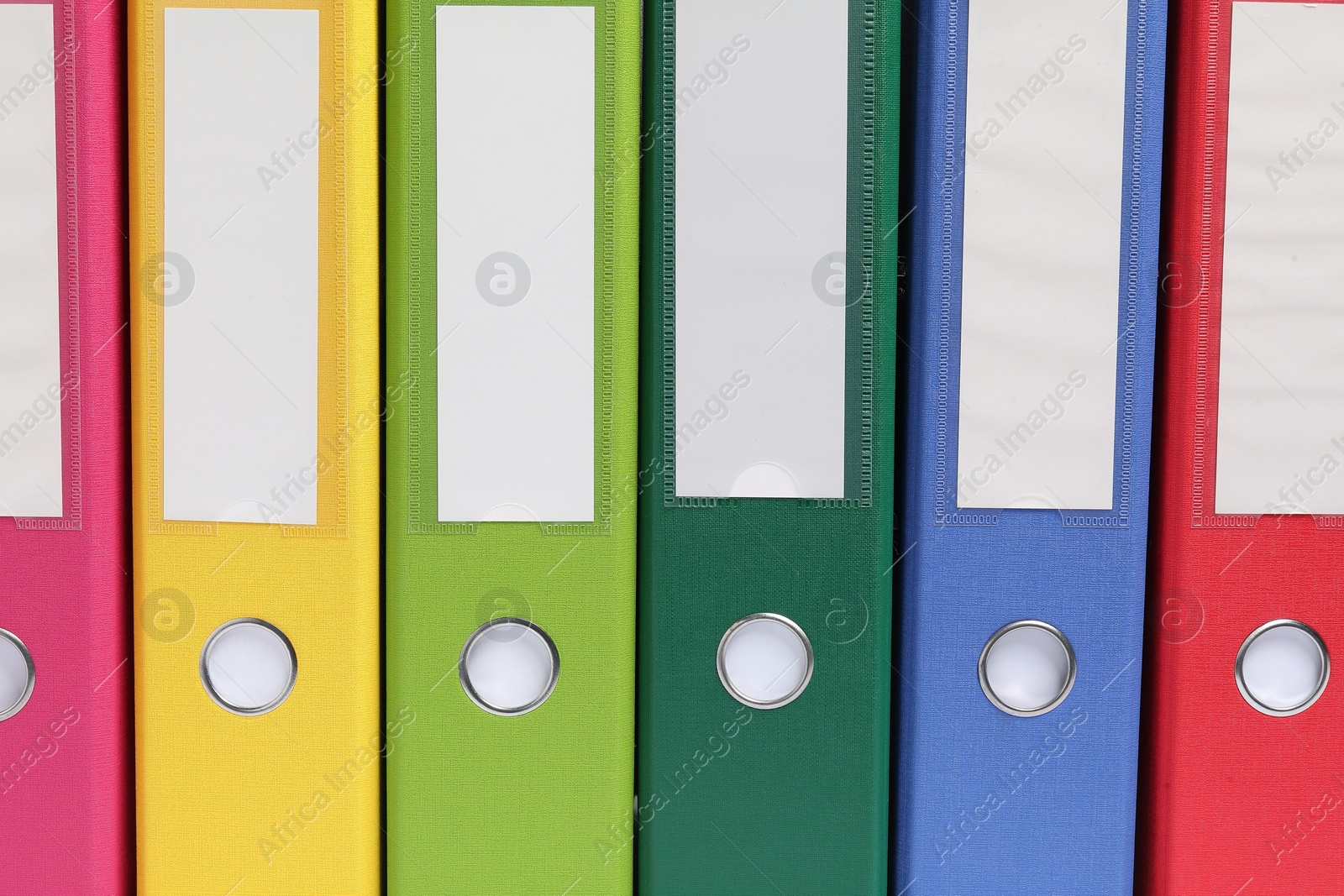 Photo of Bright binder office folders as background, closeup