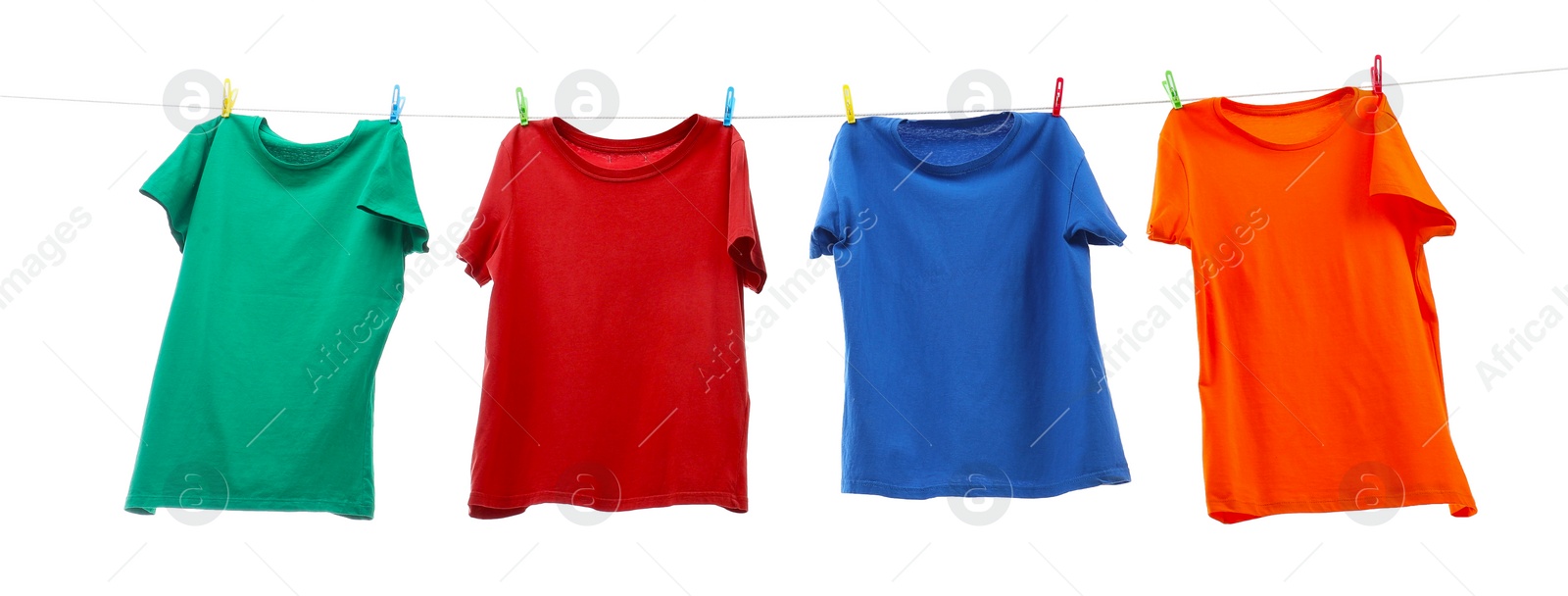 Photo of Colorful t-shirts drying on washing line isolated on white