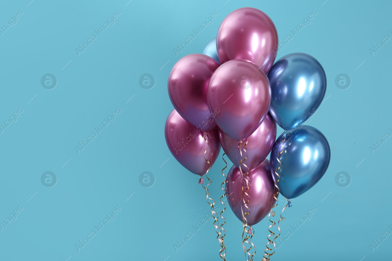 Photo of Bunch of bright balloons on color background. Space for text