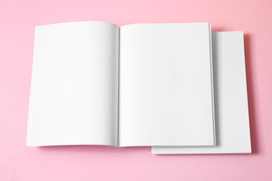 Photo of Empty book pages on pink background, top view. Mockup for design