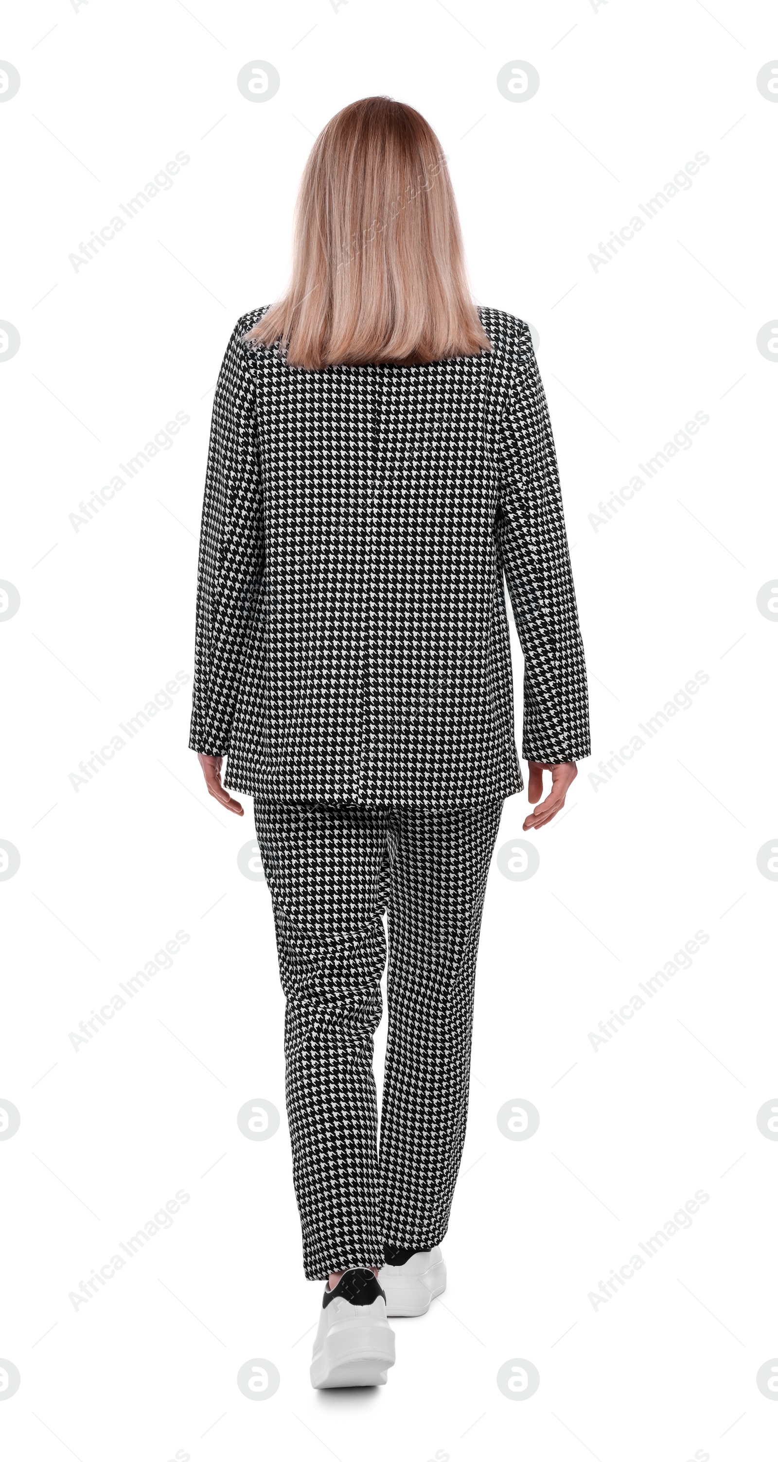 Photo of Businesswoman in suit walking on white background, back view