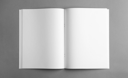 Photo of Mockup of open blank brochure on grey background, top view