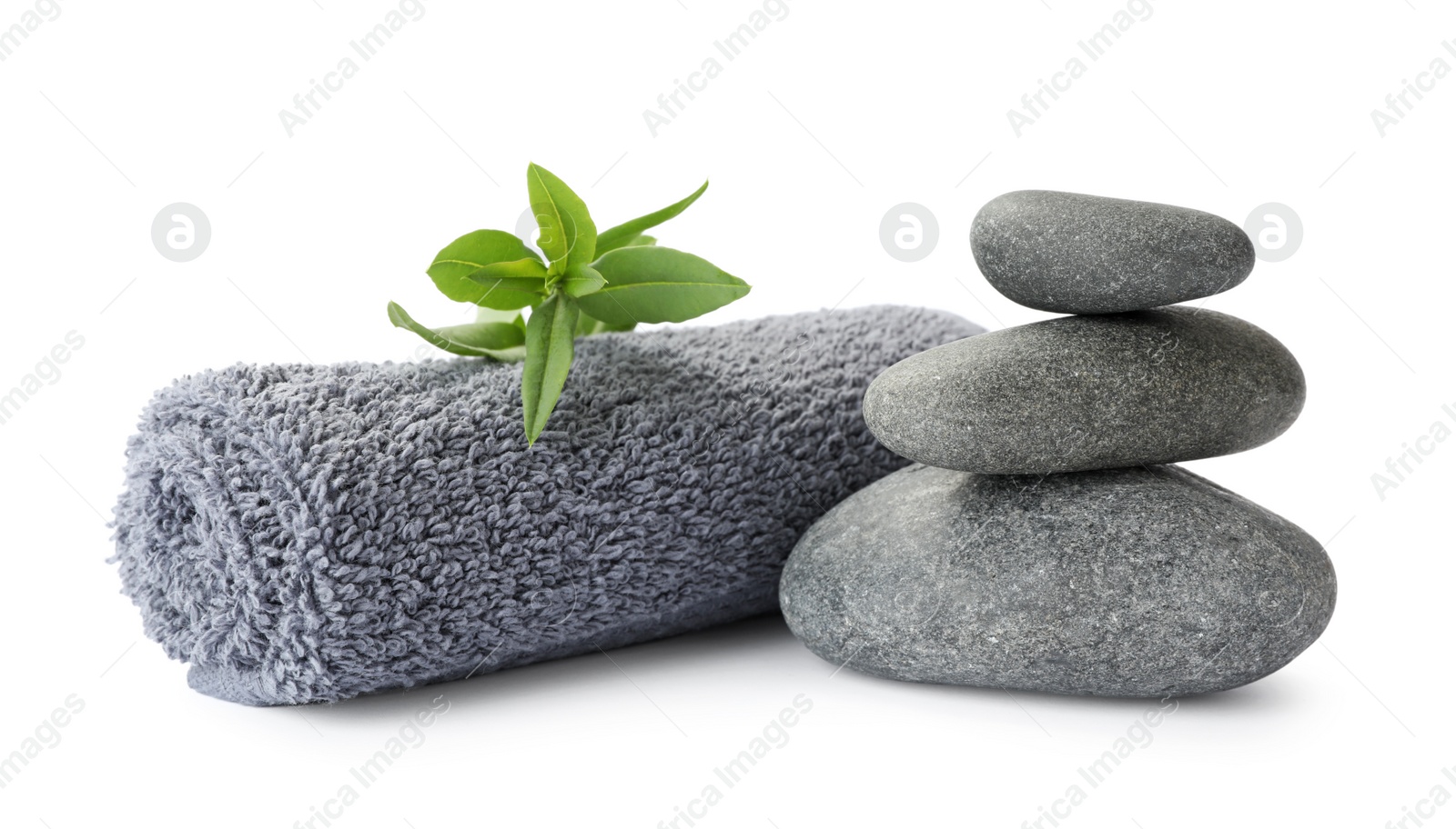 Photo of Spa stones, green leaves and towel on white background