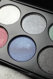 Beautiful eye shadow palette on grey table, closeup