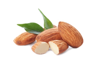 Photo of Organic almond nuts and leaves on white background. Healthy snack