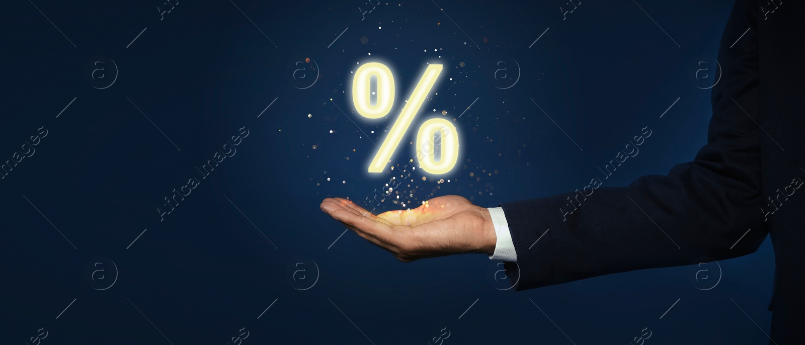 Image of Mortgage. Man holding percent sign on dark blue background, closeup. Banner design with space for text