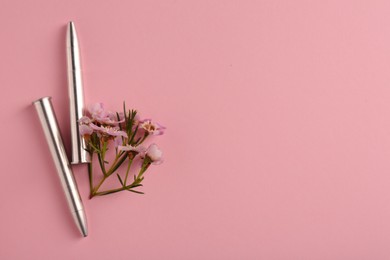 Bullets and beautiful flowers on pink background, flat lay. Space for text