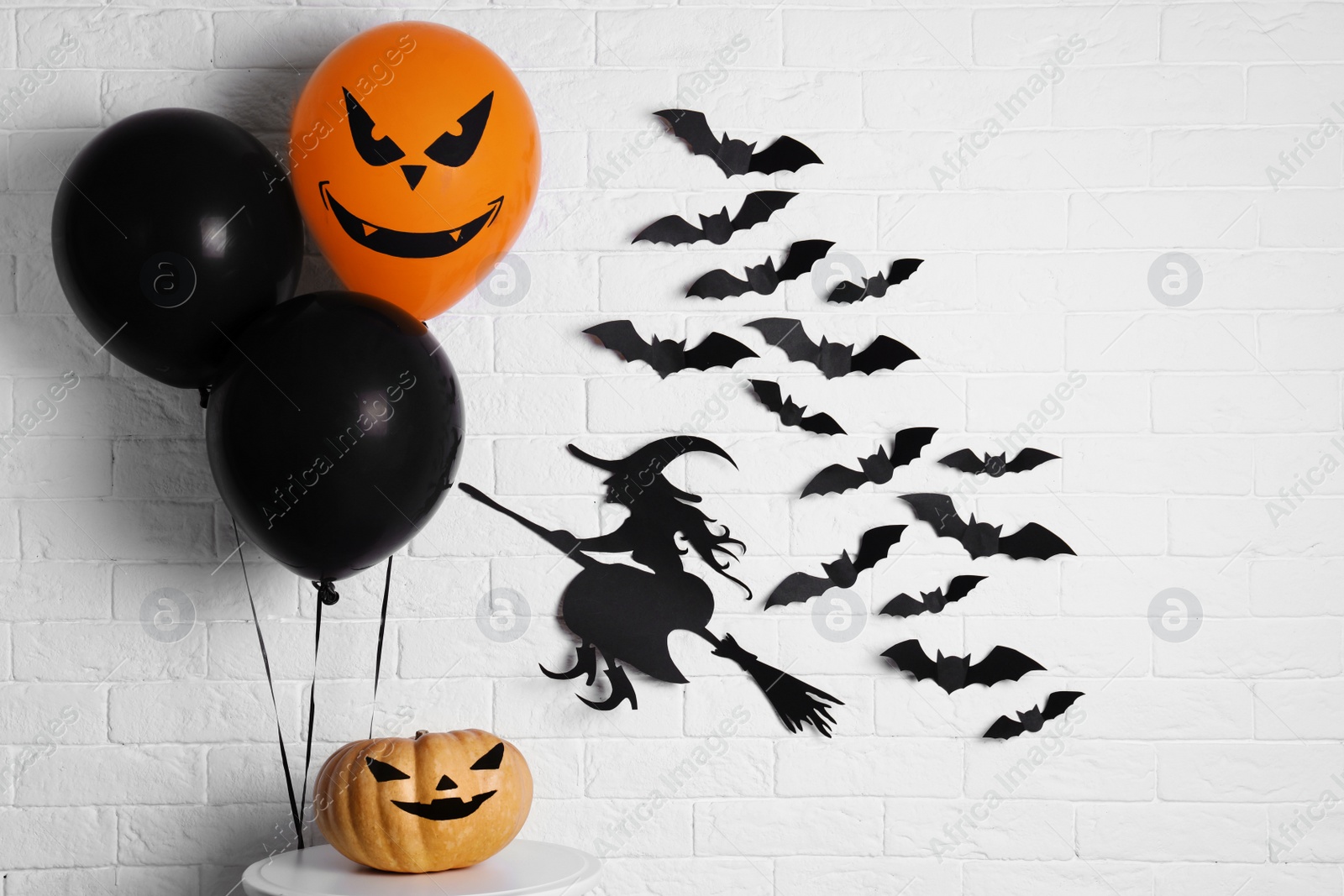 Photo of Set of Halloween decorations near brick wall