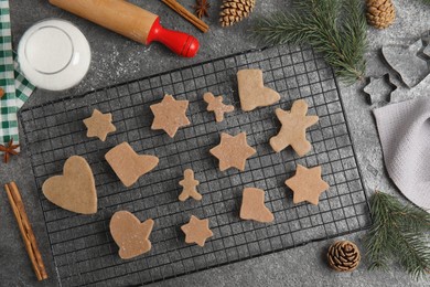 Photo of Homemade Christmas cookies. Flat lay composition with raw gingerbread biscuits on grey table