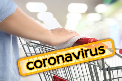 Preventive measure in public places during coronavirus outbreak. Woman holding shopping cart handle with tissue paper at supermarket, closeup 