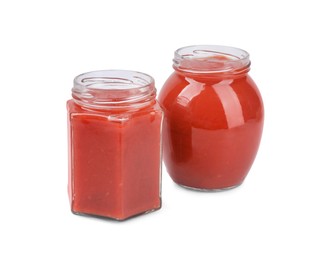 Organic ketchup in glass jars isolated on white. Tomato sauce