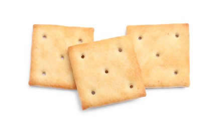 Photo of Tasty crispy square crackers isolated on white, top view