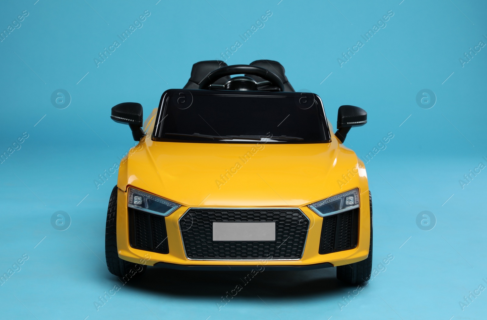 Photo of Child's electric toy car on light blue background