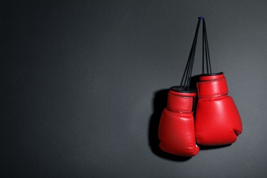 Photo of Pair of boxing gloves on grey background, space for text