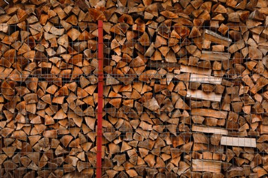 Photo of Stacked firewood as background. Heating house in winter