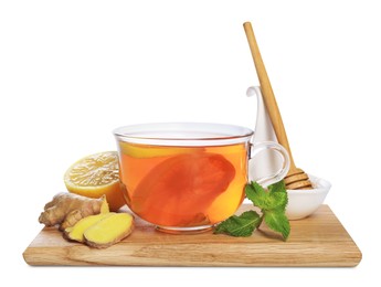 Wooden board with delicious ginger tea and ingredients on white background