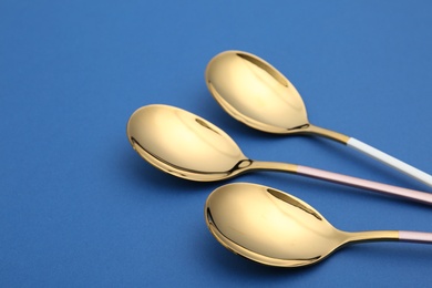 Photo of Set of clean tablespoons on color background