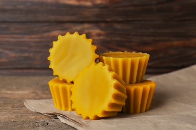 Natural beeswax cake blocks on wooden table, closeup