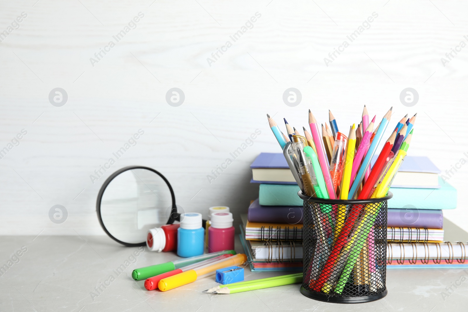 Photo of Different school stationery on table against light background