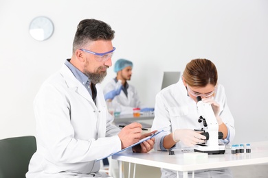 Photo of Scientists working in laboratory. Research and analysis