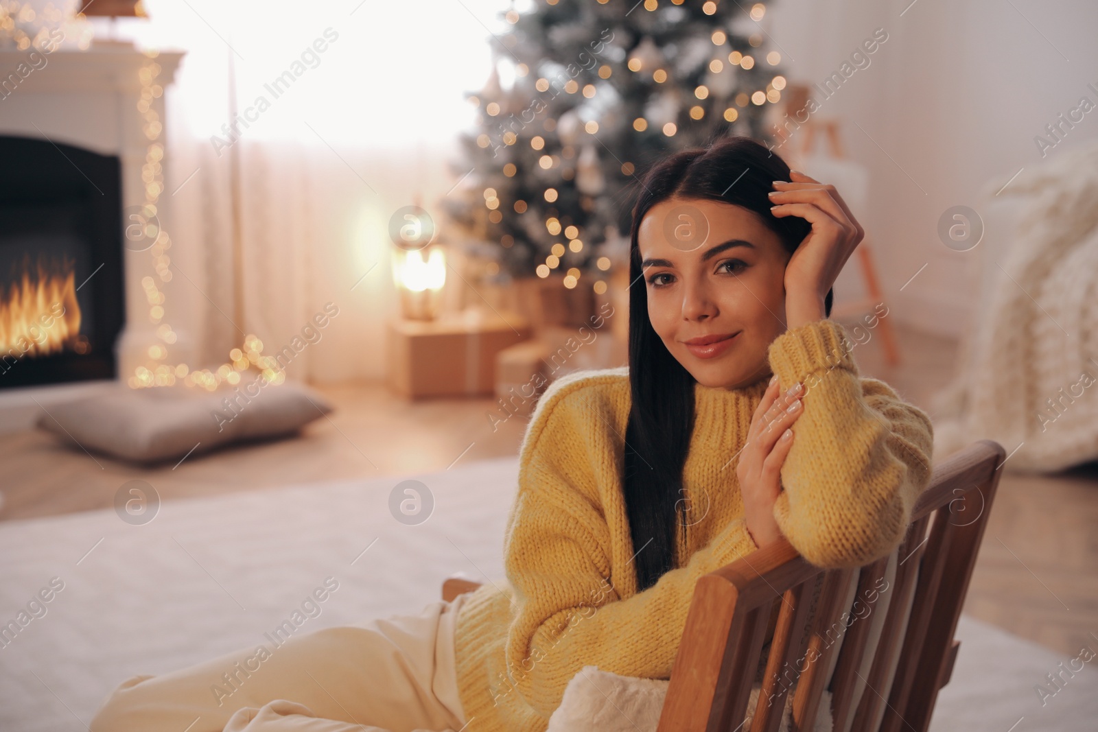 Photo of Young woman in armchair at home, space for text. Christmas celebration