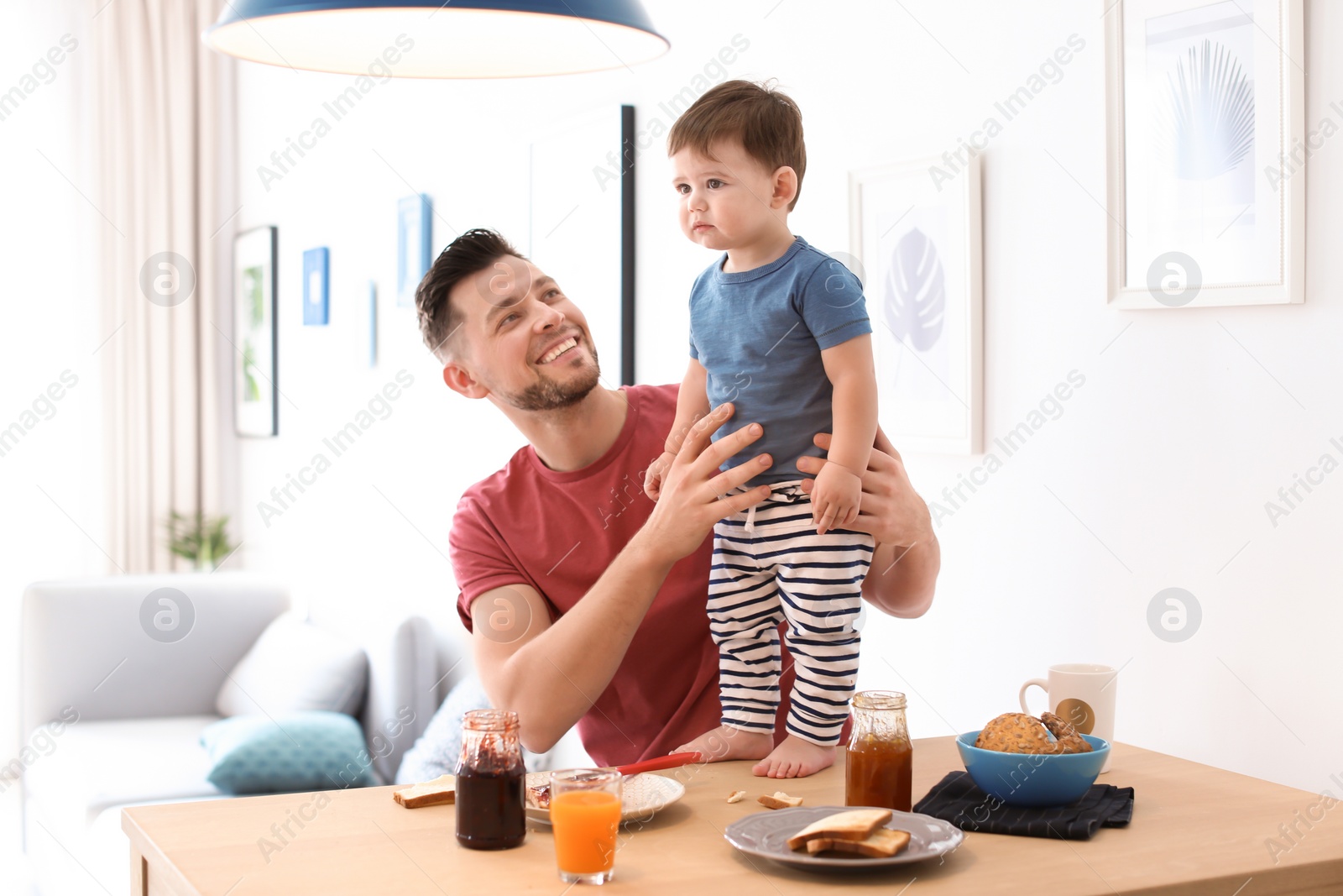 Photo of Dad and his son having breakfast in kitchen