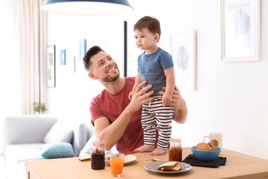 Dad and his son having breakfast in kitchen