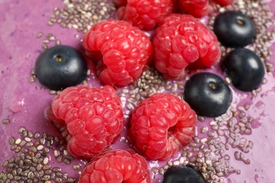 Delicious acai smoothie with raspberries and chia seeds as background, closeup