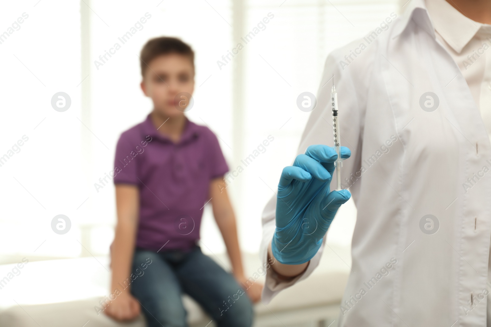Photo of Doctor with syringe in clinic, closeup. Vaccination day