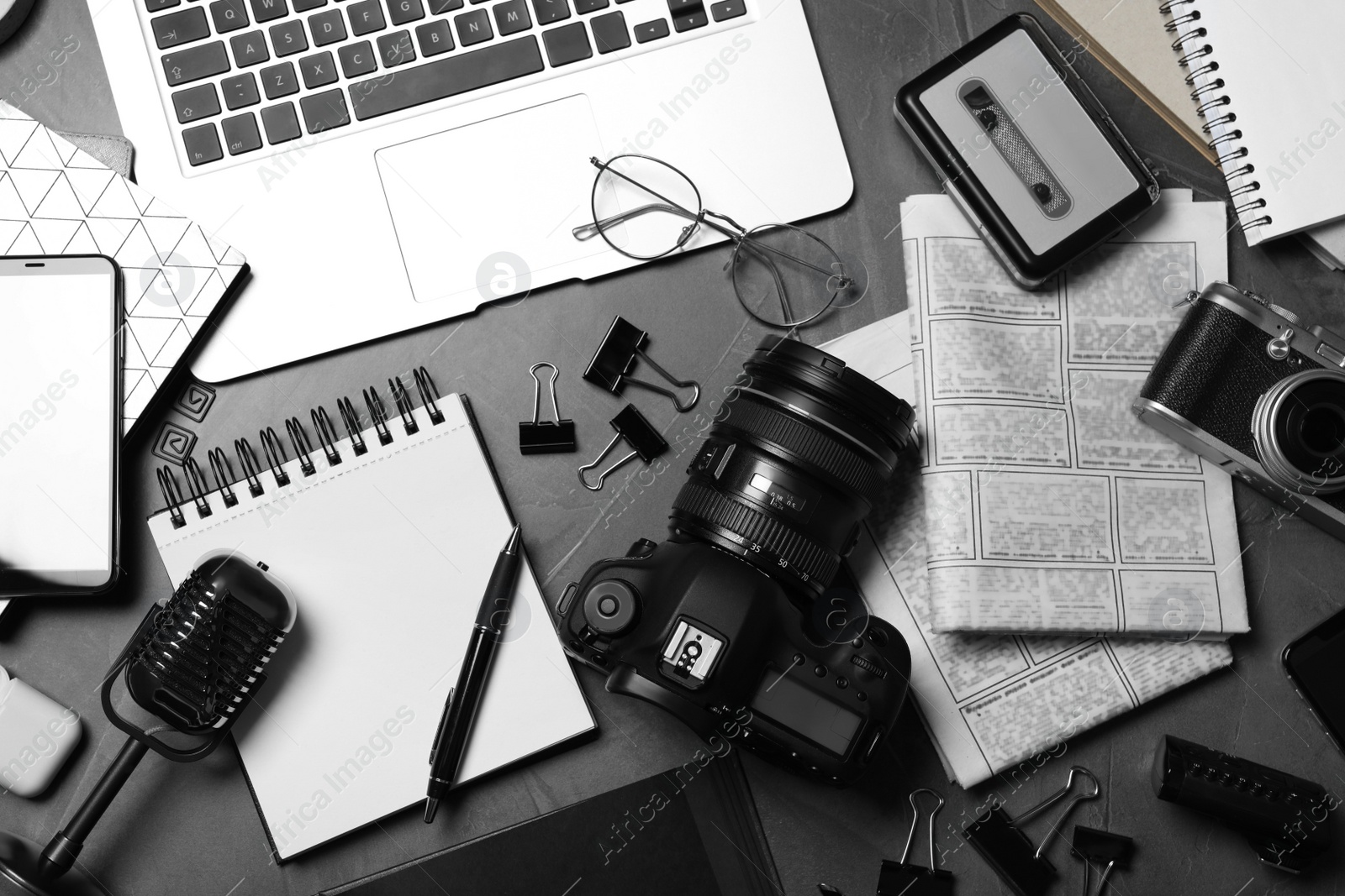 Photo of Flat lay composition with equipment for journalist on grey table