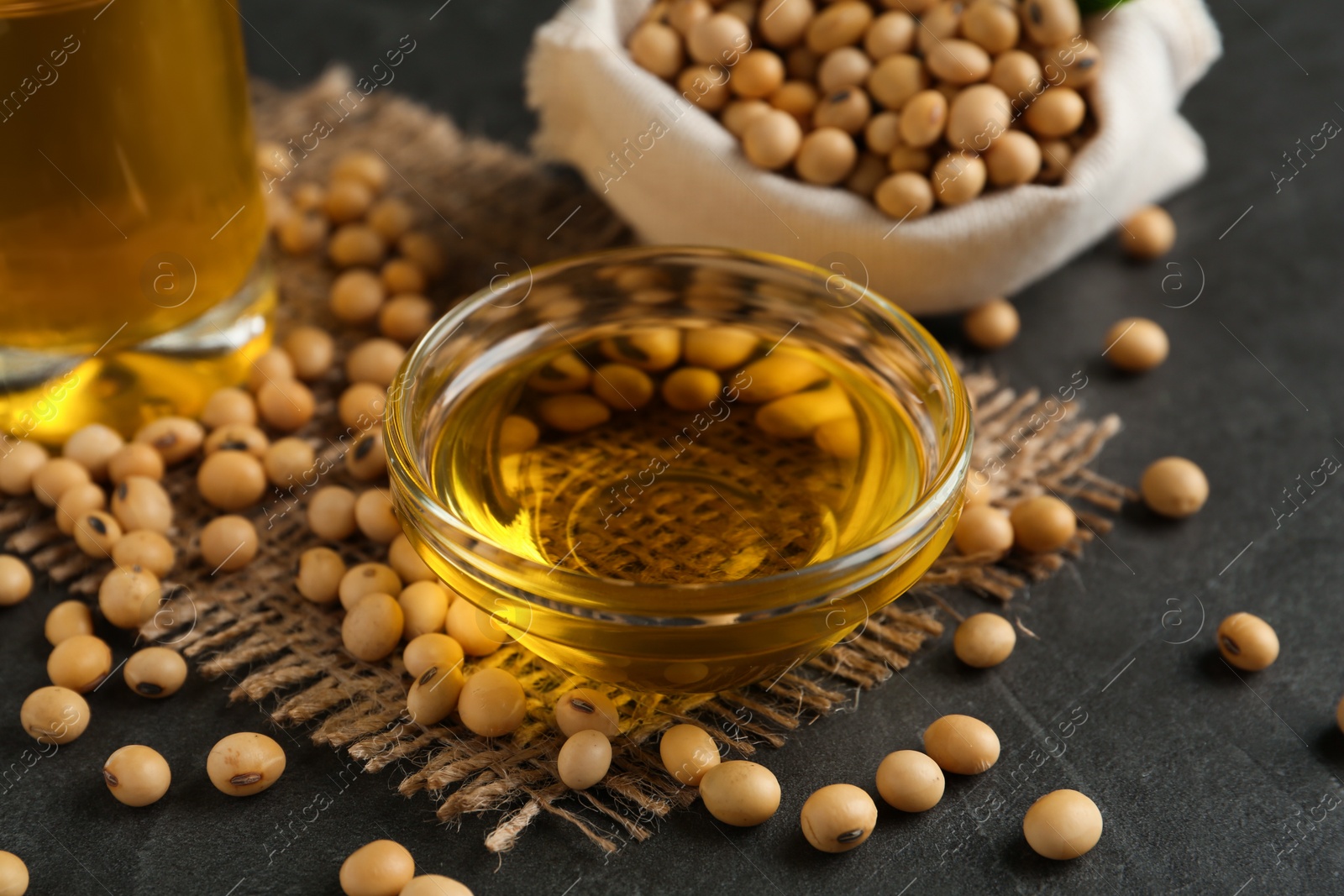 Photo of Composition with soybean oil on grey table, closeup